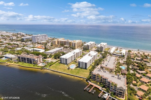 drone / aerial view featuring a view of city and a water view