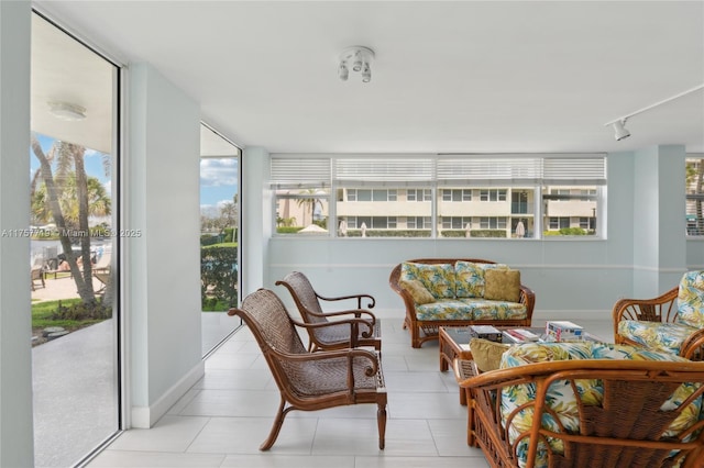 1236 Hillsboro Mile Unit 403, Hillsboro Beach, FL 33062 - sunroom featuring track lighting, baseboards, and tile patterned flooring