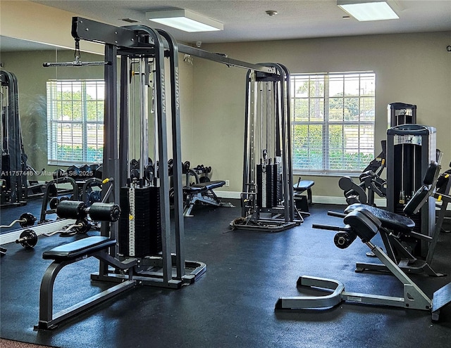 workout area featuring baseboards