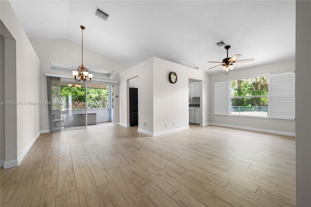 8904 SW Fishermans Wharf Dr, Stuart, FL 34997 - unfurnished living room with a chandelier, plenty of natural light, ceiling fan, baseboards, and vaulted ceiling