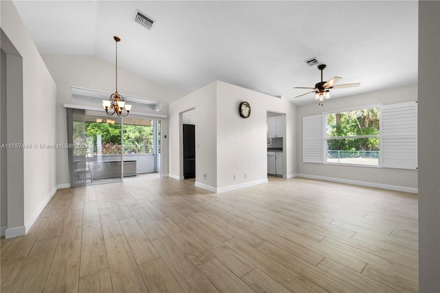 8904 SW Fishermans Wharf Dr, Stuart, FL 34997 - unfurnished living room with a chandelier, healthy amount of natural light, ceiling fan, baseboards, and lofted ceiling