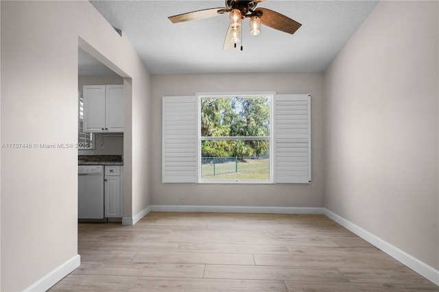 8904 SW Fishermans Wharf Dr, Stuart, FL 34997 - empty room featuring a ceiling fan, light wood-type flooring, baseboards, and a textured ceiling