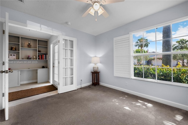 8904 SW Fishermans Wharf Dr, Stuart, FL 34997 - carpeted empty room featuring french doors, healthy amount of natural light, ceiling fan, and baseboards