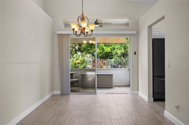 8904 SW Fishermans Wharf Dr, Stuart, FL 34997 - unfurnished room featuring healthy amount of natural light, wood finished floors, a chandelier, and baseboards