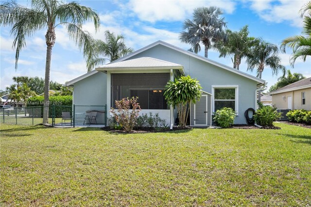8904 SW Fishermans Wharf Dr, Stuart, FL 34997 - view of front of property featuring a gate, stucco siding, central air condition unit, and a sunroom