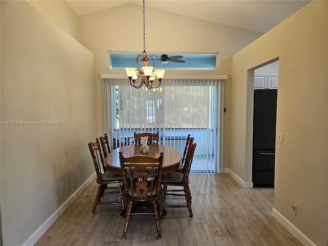 8904 SW Fishermans Wharf Dr, Stuart, FL 34997 - dining area with a chandelier, wood finished floors, high vaulted ceiling, and baseboards