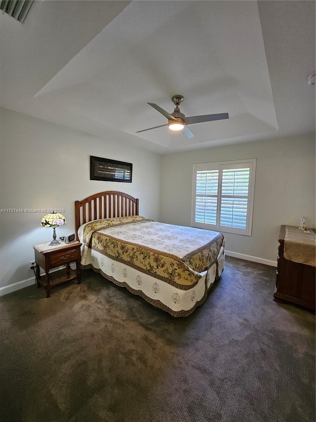 8904 SW Fishermans Wharf Dr, Stuart, FL 34997 - bedroom with dark carpet, baseboards, ceiling fan, and a raised ceiling