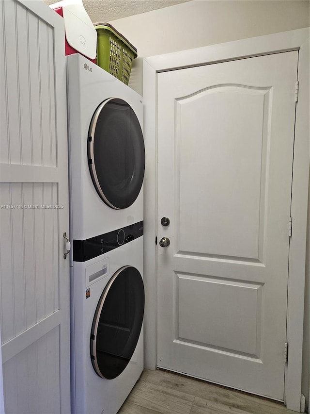 8904 SW Fishermans Wharf Dr, Stuart, FL 34997 - laundry area featuring estacked washer and dryer and light wood-style floors