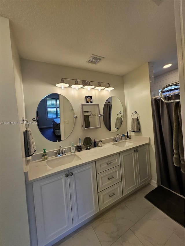 8904 SW Fishermans Wharf Dr, Stuart, FL 34997 - full bath with marble finish flooring, double vanity, a textured ceiling, and curtained shower
