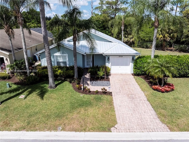 8904 SW Fishermans Wharf Dr, Stuart, FL 34997 - ranch-style home with an attached garage, stucco siding, and a front lawn