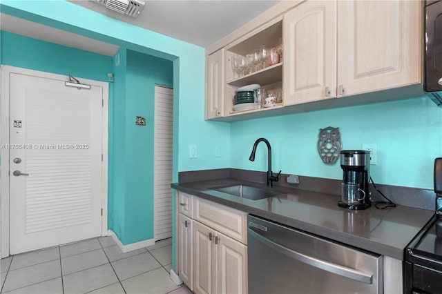 kitchen featuring light tile patterned floors, visible vents, dishwasher, dark countertops, and a sink