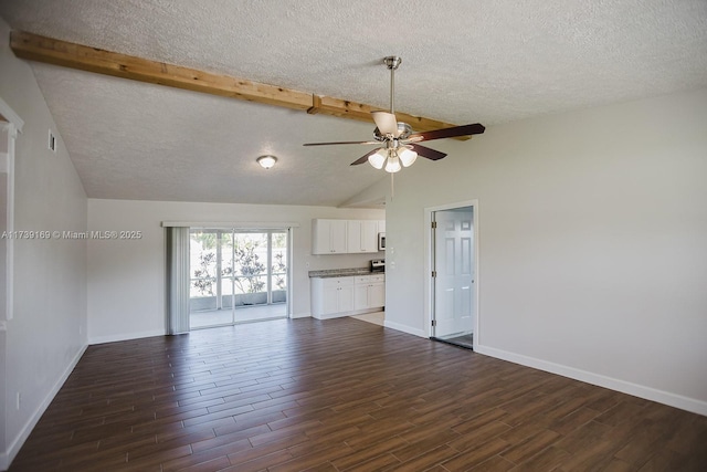 unfurnished living room featuring vaulted ceiling with beams, dark wood-type flooring, a ceiling fan, a textured ceiling, and baseboards