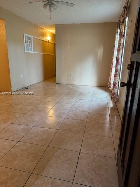 spare room featuring light tile patterned floors and a ceiling fan