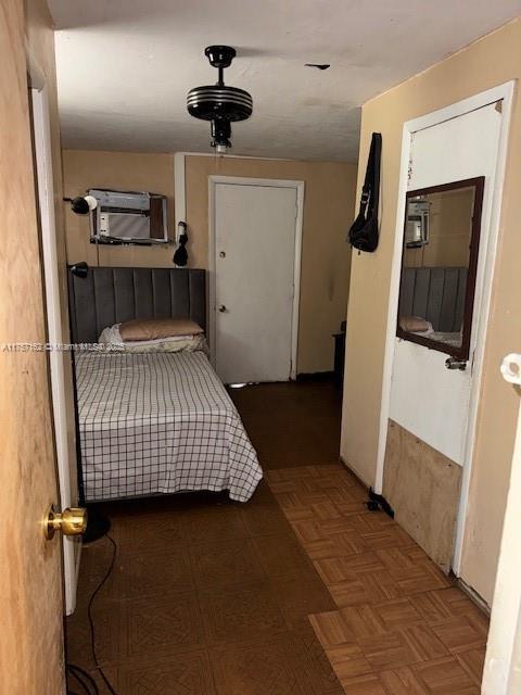 bedroom with an AC wall unit