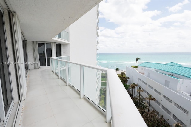 balcony with a view of the beach and a water view