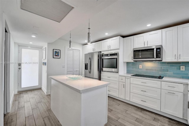 kitchen with wood tiled floor, visible vents, stainless steel appliances, and backsplash