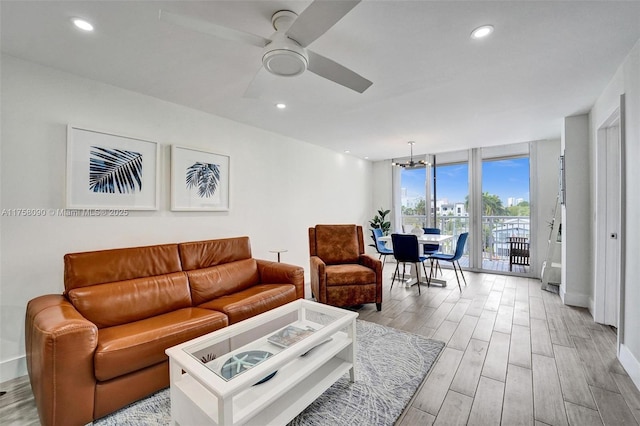 living room with expansive windows, wood finish floors, and recessed lighting