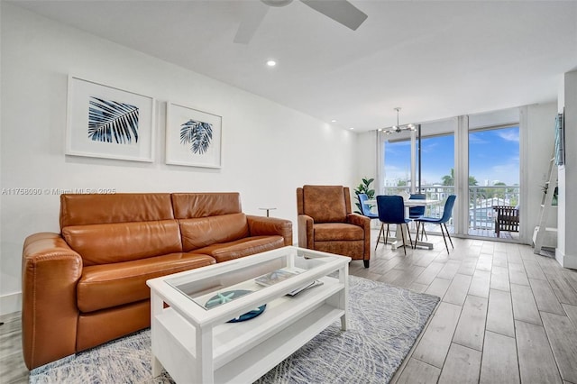 living area with a ceiling fan, recessed lighting, light wood-style flooring, and floor to ceiling windows