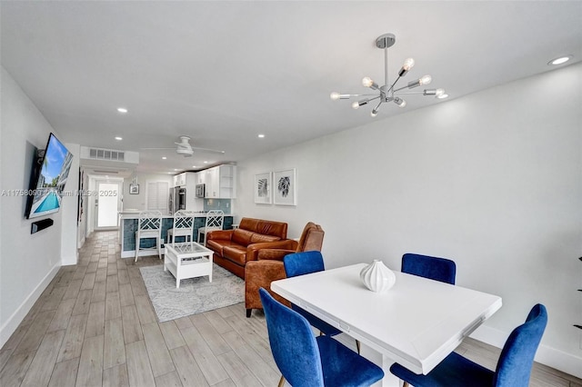 dining room featuring a chandelier, recessed lighting, light wood-style flooring, and baseboards