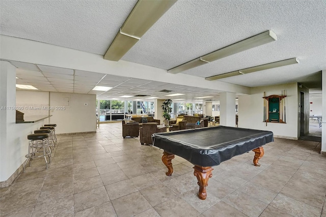 playroom with a drop ceiling, plenty of natural light, baseboards, and billiards