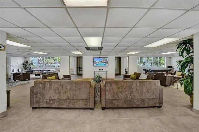 living room with a healthy amount of sunlight and a drop ceiling