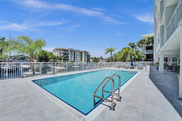 pool with fence and a patio