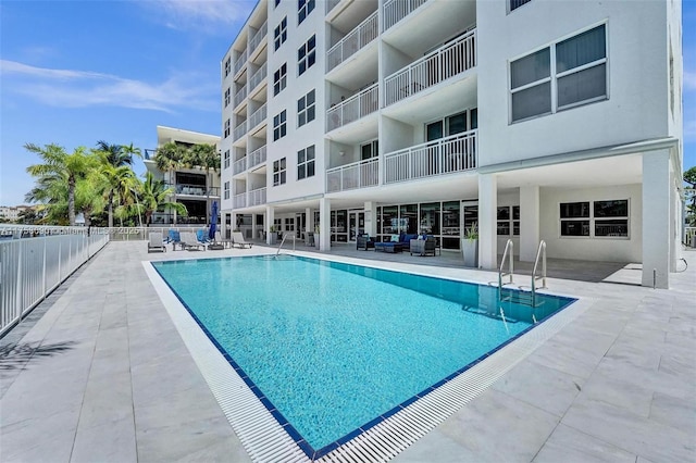 pool with fence and a patio