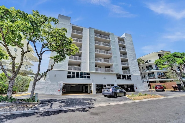 view of building exterior featuring uncovered parking