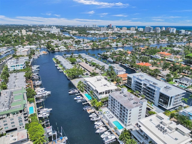 birds eye view of property with a water view and a city view