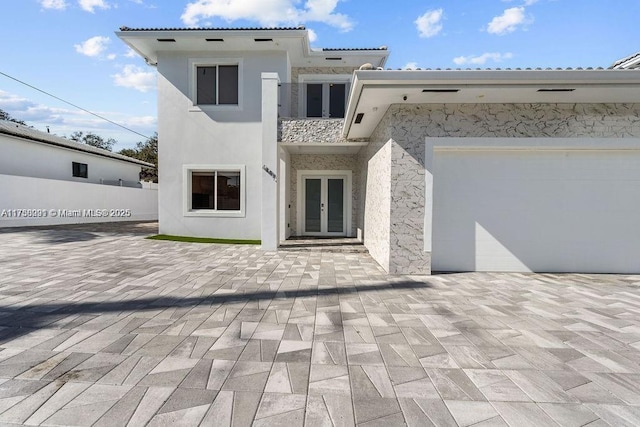 view of front of property featuring stucco siding and french doors