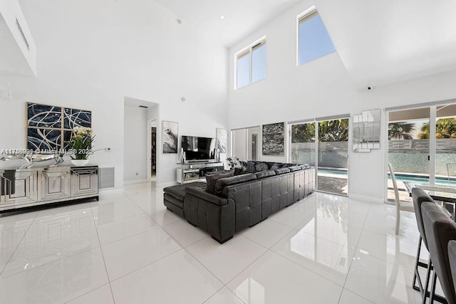 living area with light tile patterned floors, visible vents, and a wealth of natural light