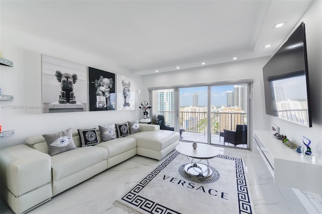 living area featuring recessed lighting and marble finish floor