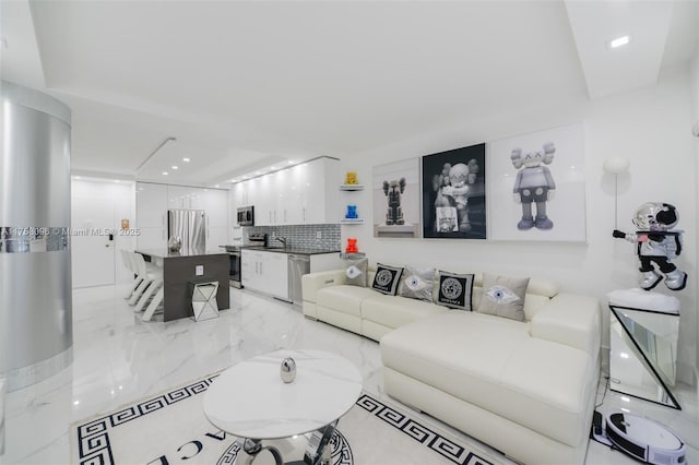 living room featuring recessed lighting and marble finish floor