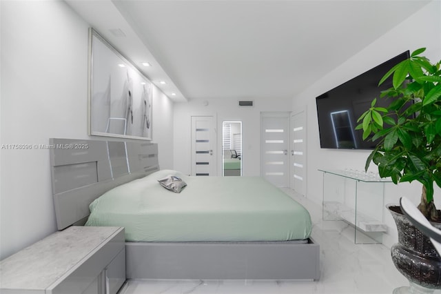 bedroom with marble finish floor and visible vents