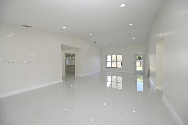 empty room featuring marble finish floor, baseboards, vaulted ceiling, and recessed lighting