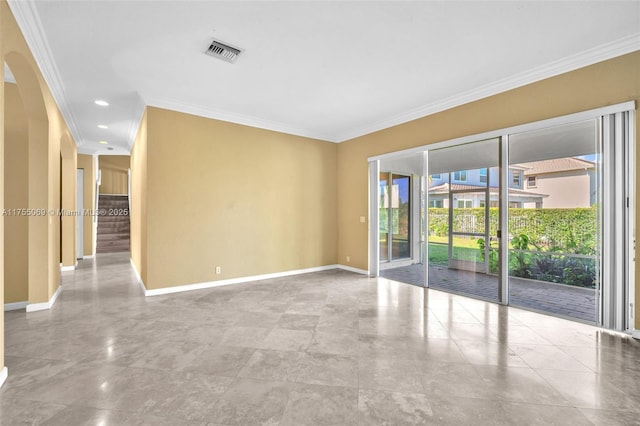 spare room with baseboards, visible vents, and ornamental molding