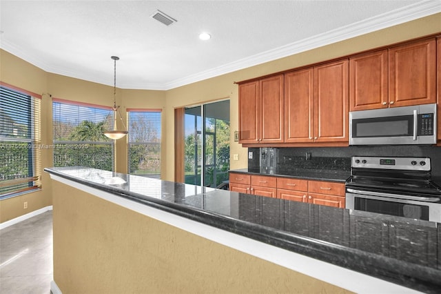 kitchen with stainless steel appliances, visible vents, dark stone counters, brown cabinetry, and crown molding