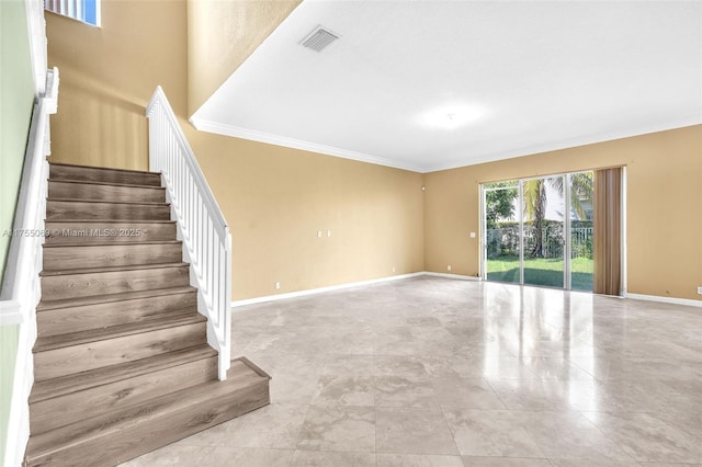 staircase with ornamental molding, visible vents, and baseboards