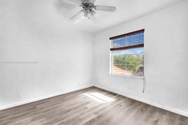 spare room with ceiling fan, baseboards, and wood finished floors