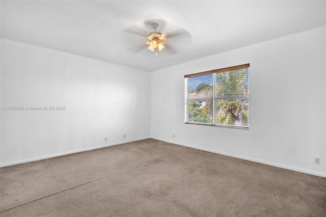 unfurnished room featuring carpet floors, a ceiling fan, and baseboards