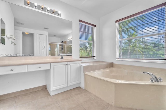 bathroom with a bath, tile patterned flooring, vanity, and a shower stall