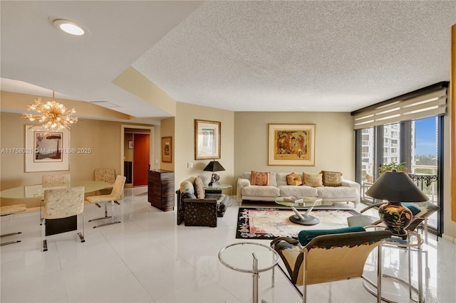 living area featuring a chandelier, tile patterned flooring, a textured ceiling, and expansive windows