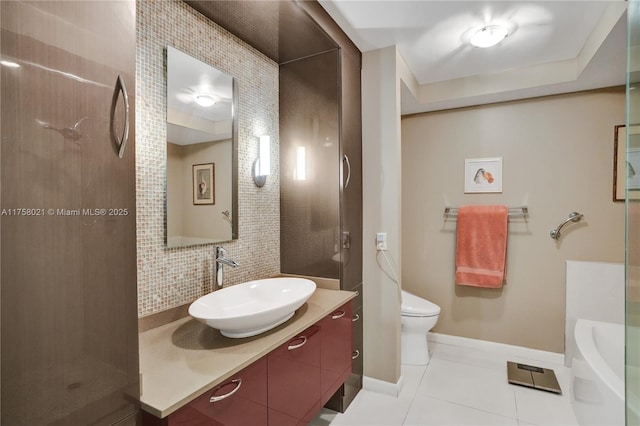 full bath with toilet, vanity, baseboards, backsplash, and tile patterned floors