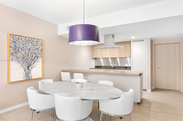 dining room featuring baseboards and visible vents