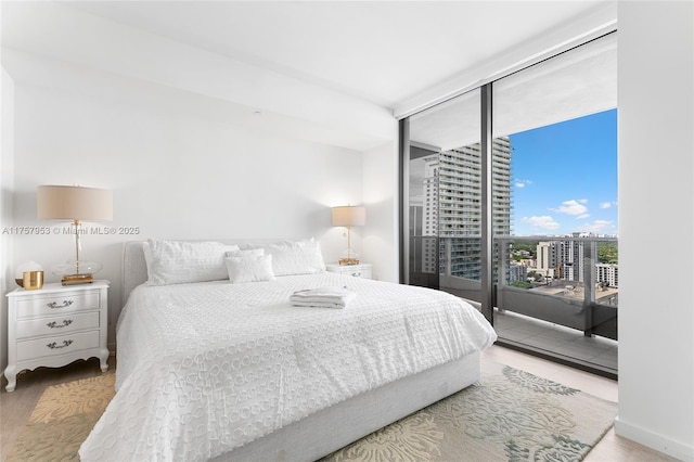 bedroom featuring a view of city and access to outside