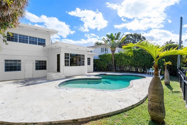 view of swimming pool featuring a patio area, fence, and a fenced in pool