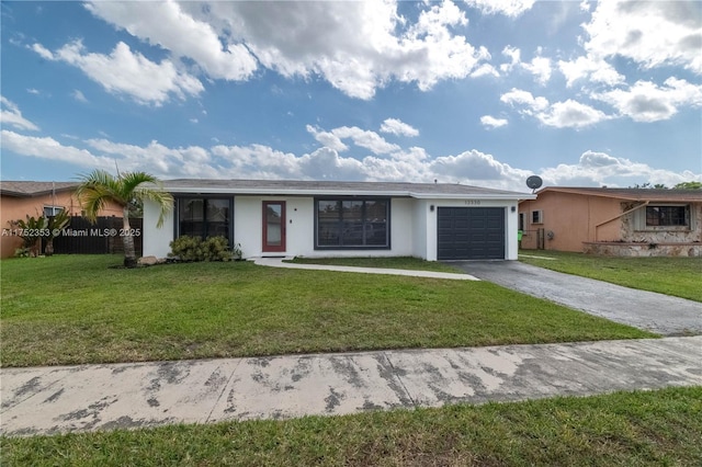 view of front of home featuring stucco siding, an attached garage, fence, driveway, and a front lawn