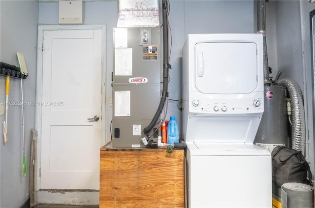 washroom with heating unit, stacked washing maching and dryer, and laundry area