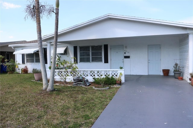 view of front of house featuring a front lawn and stucco siding