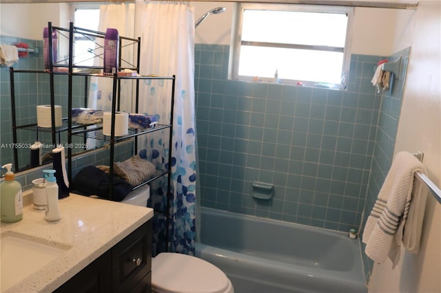 full bathroom featuring shower / bath combo, vanity, and toilet